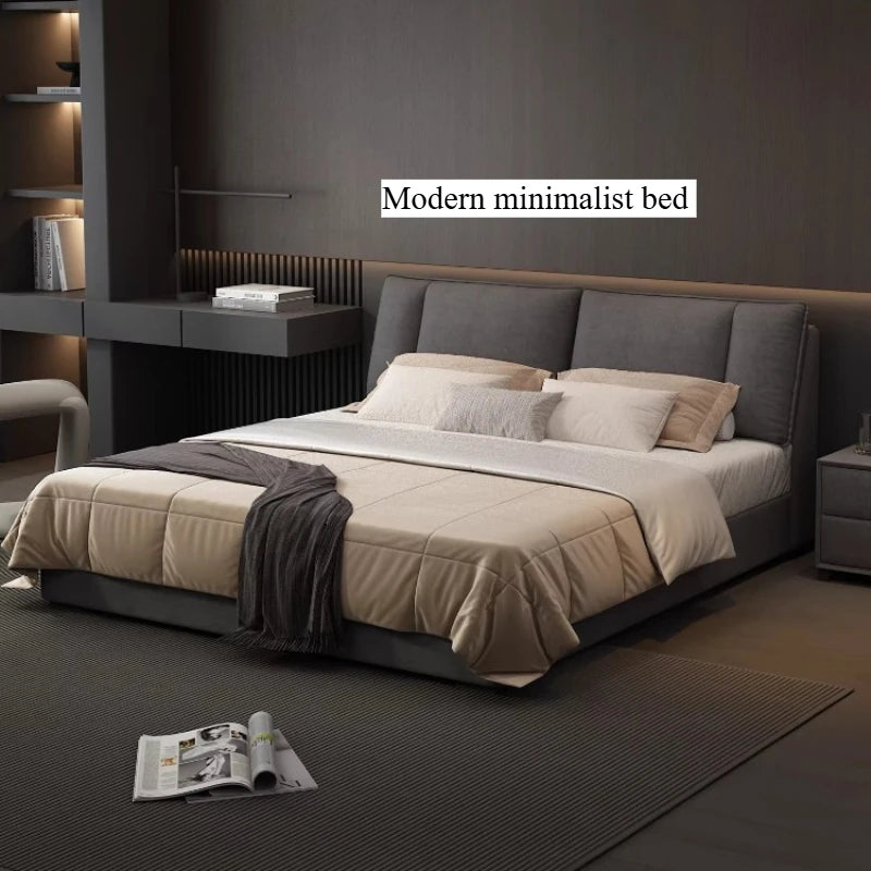 Modern grey upholstered double bed with a sleek, minimalist headboard and integrated under-bed storage.