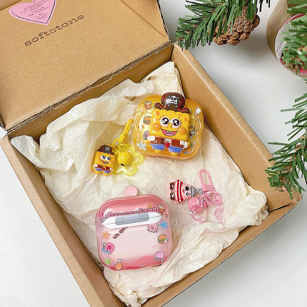 Yellow and pink silicone SpongeBob and Patrick AirPods cases with charms, inside a gift box.