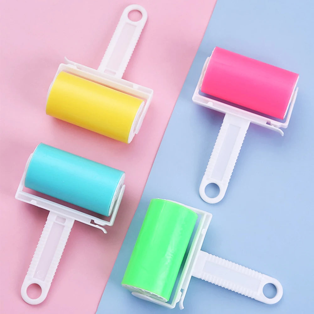Four colourful lint rollers with white plastic handles, shown in yellow, pink, turquoise, and lime green.