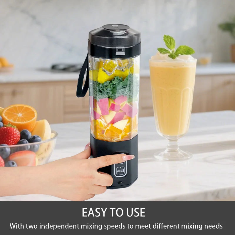 A hand presses the pulse button on a black, portable personal blender filled with layers of fresh fruit and vegetables.