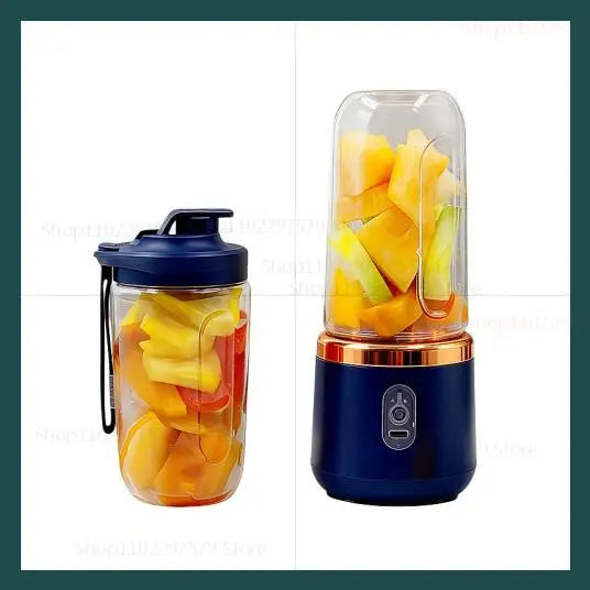 Portable personal blender with a navy base, gold rim, and clear cup filled with chopped fruit and a navy lid.