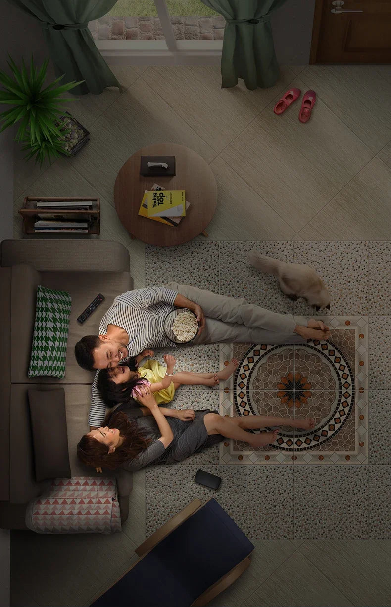 A family relaxes on a sofa beside decorative floor tiles featuring a circular geometric pattern in earthy, neutral tones.
