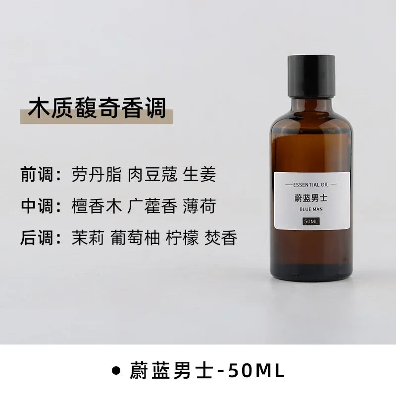 50ml amber glass bottle of men’s essential oil with a black cap and white label, featuring woody and citrus scent notes.