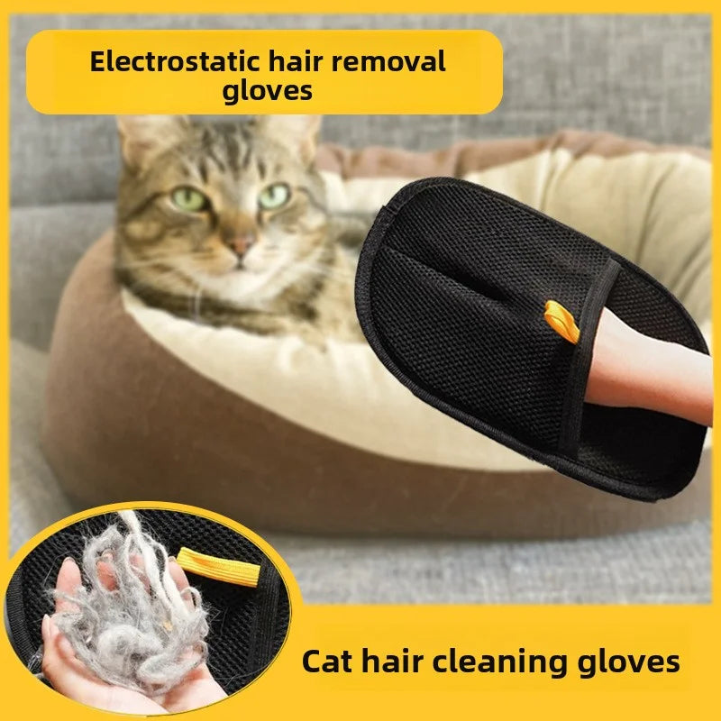 Black electrostatic hair removal mitt with a small yellow strap, shown cleaning pet hair from a cat bed.