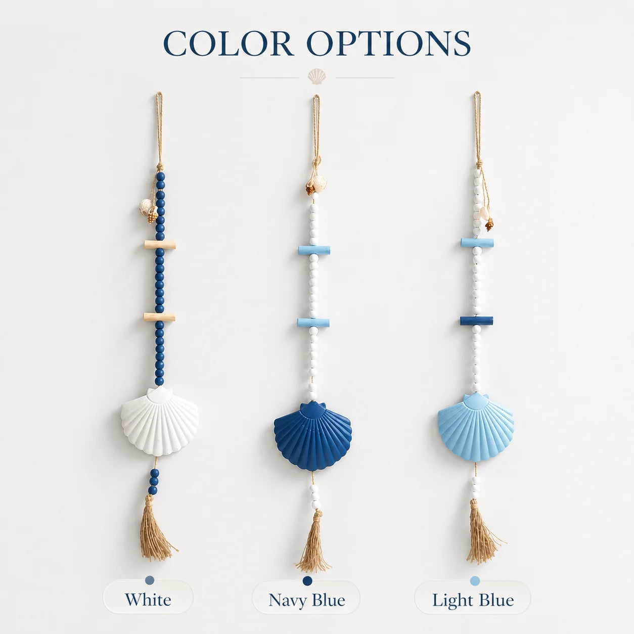 Three boho seashell wall hangings in white, navy, and light blue, featuring wooden beads and jute tassel accents.