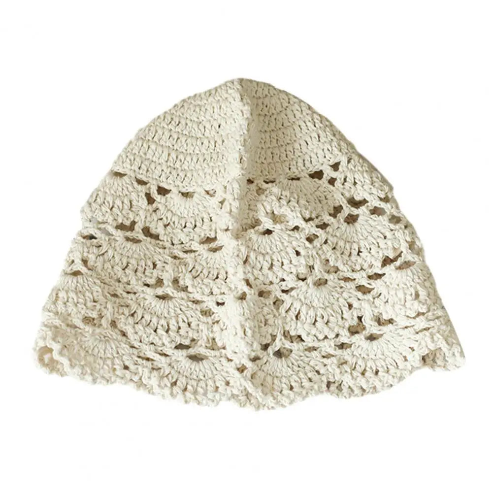 Cream-coloured crochet lace hat featuring an intricate, hollow-out scalloped pattern in a classic bucket style.