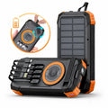 Rugged black and orange solar power bank with built-in cables, wireless charging pad, and LED torch feature.