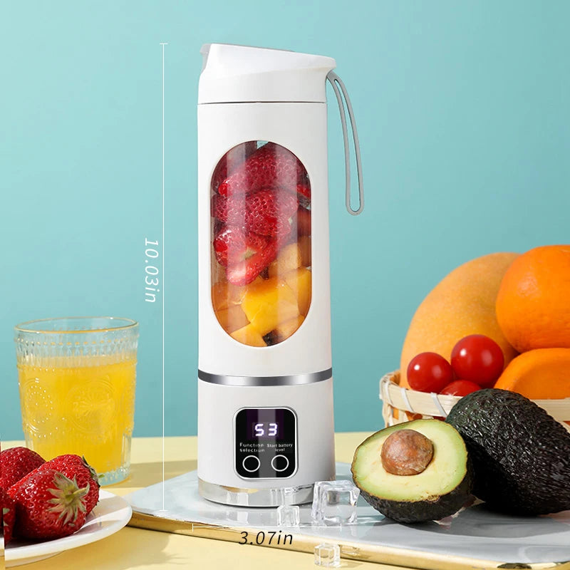 White portable blender with a clear center window, digital display, and carry strap, surrounded by fresh fruit.