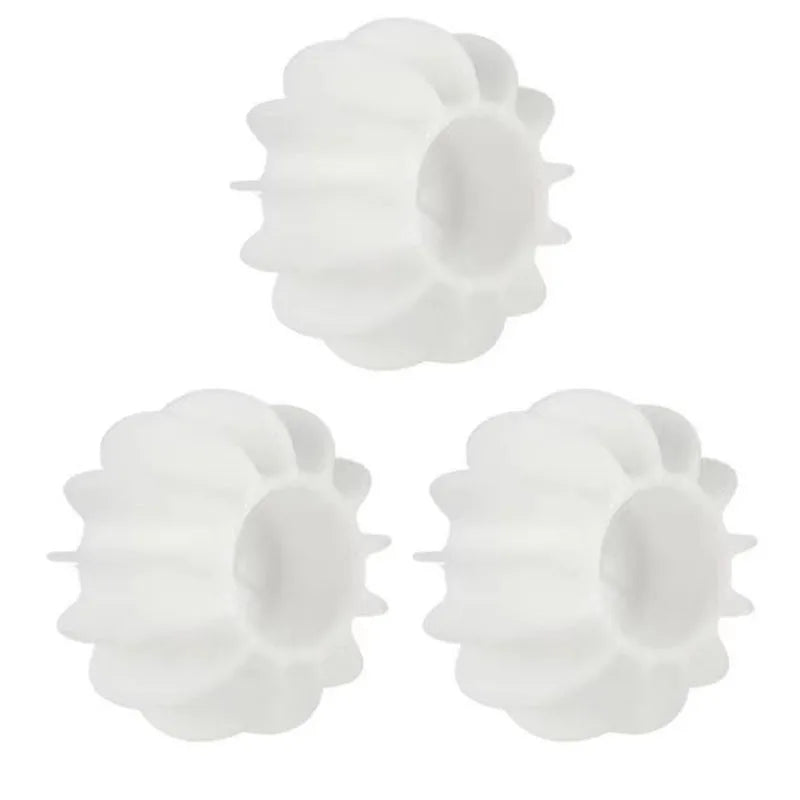 Three white, circular plastic replacement wheels with a grooved, ridged edge design.
