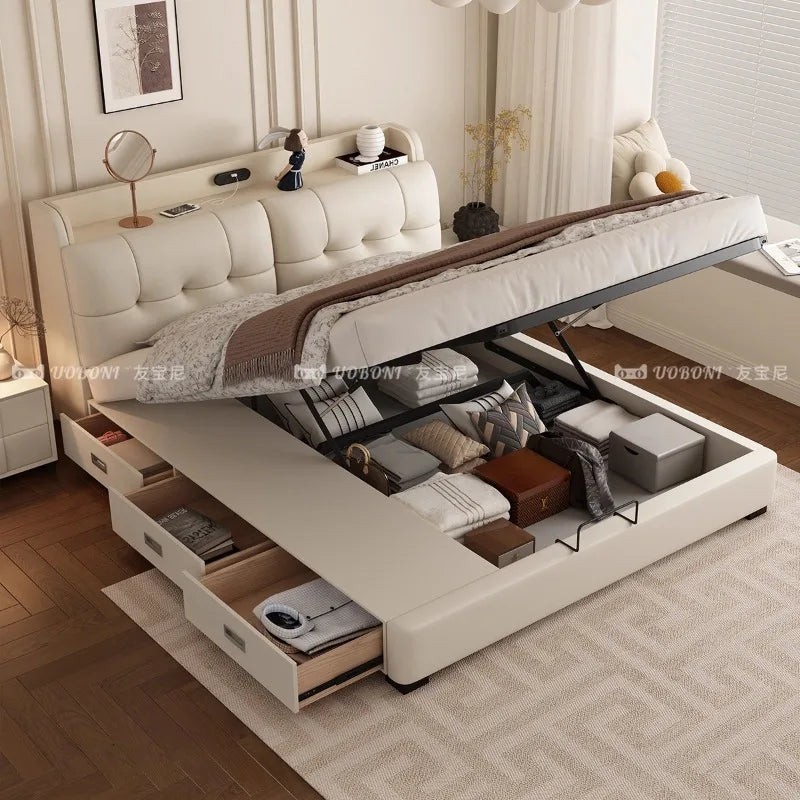 Modern cream leather ottoman bed with a tufted headboard, lift-up storage base, and side drawers.