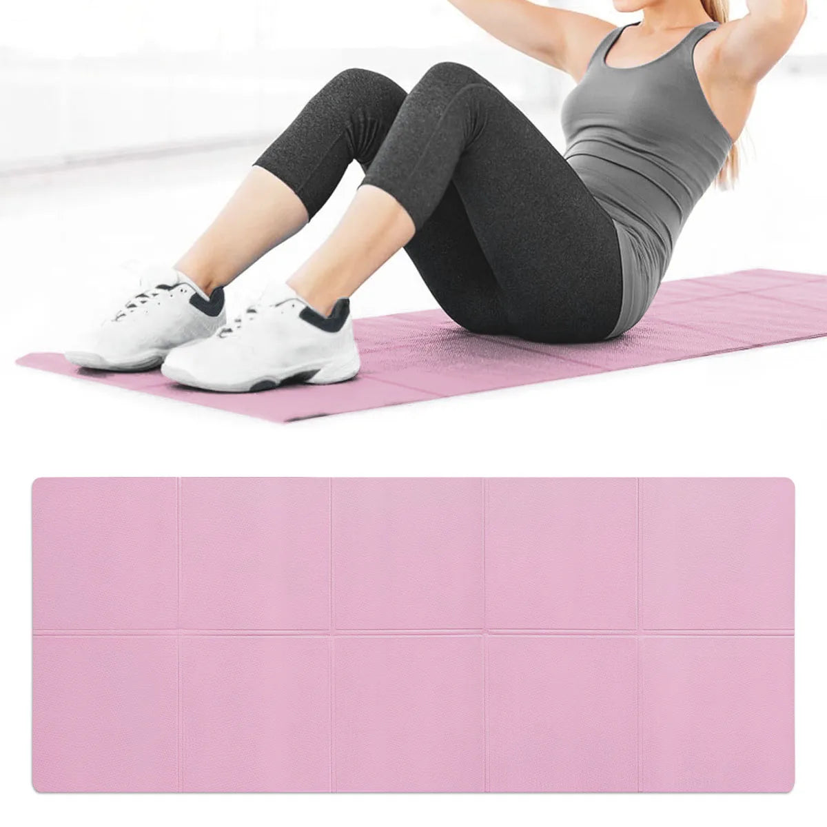 A foldable pink exercise mat with a textured surface, shown in use by a person doing sit-ups.