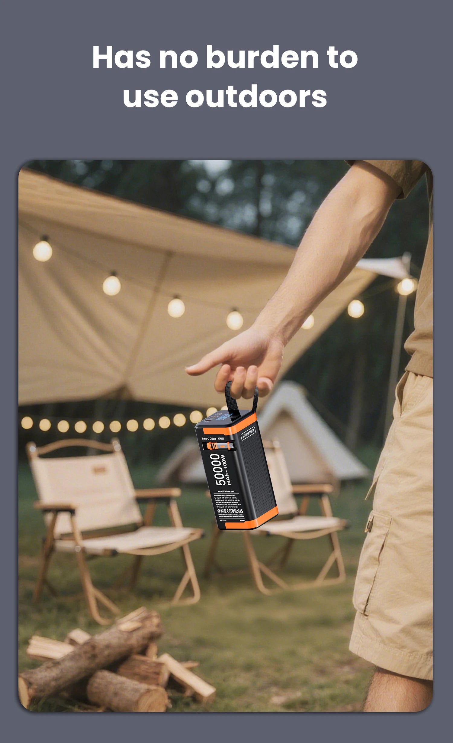Black and orange 50,000mAh portable power bank with 100W fast charging, held by a carry strap at a campsite.