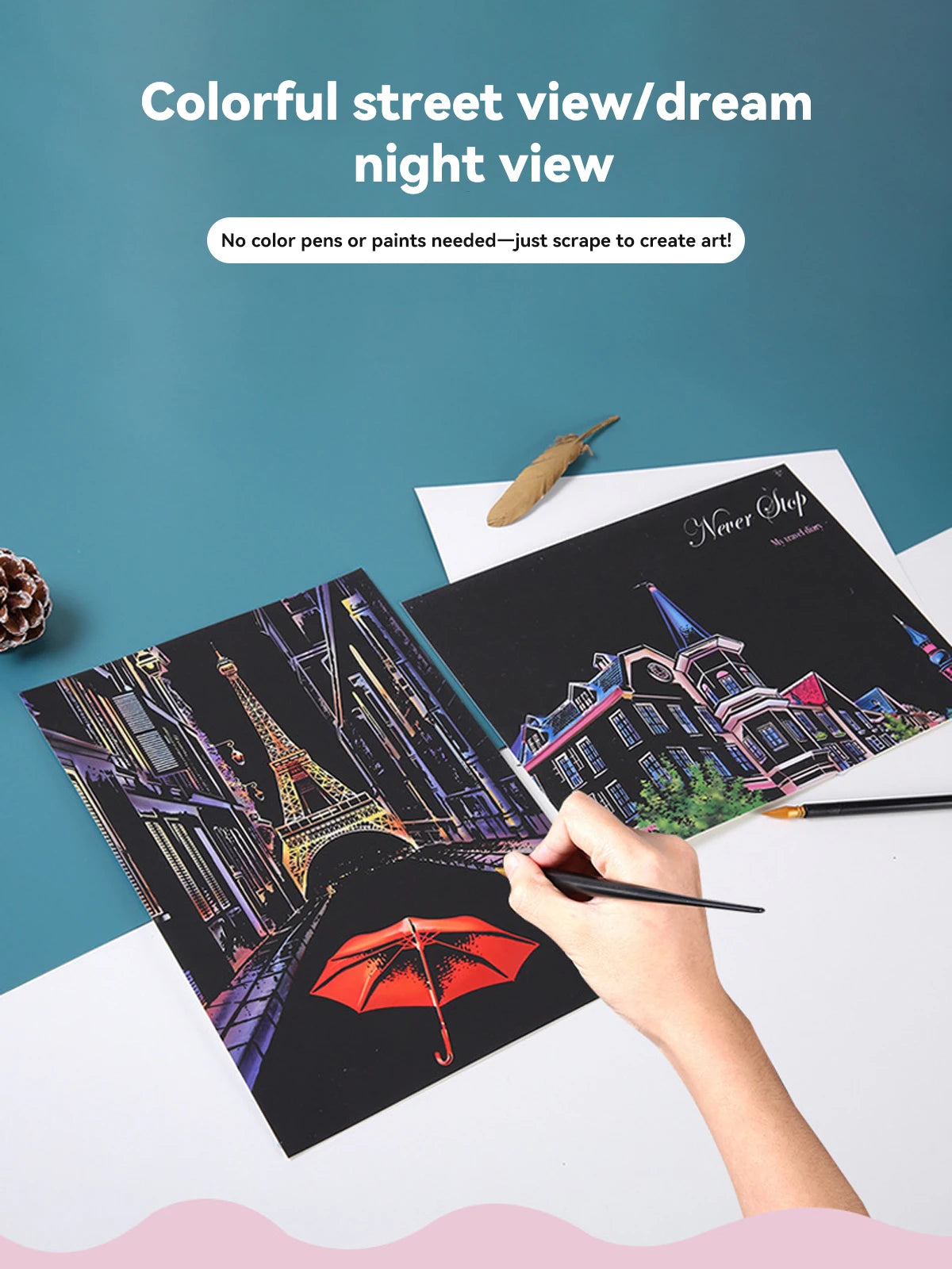 Hand scraping art set featuring two black sheets with colourful night cityscapes of Paris and European buildings.