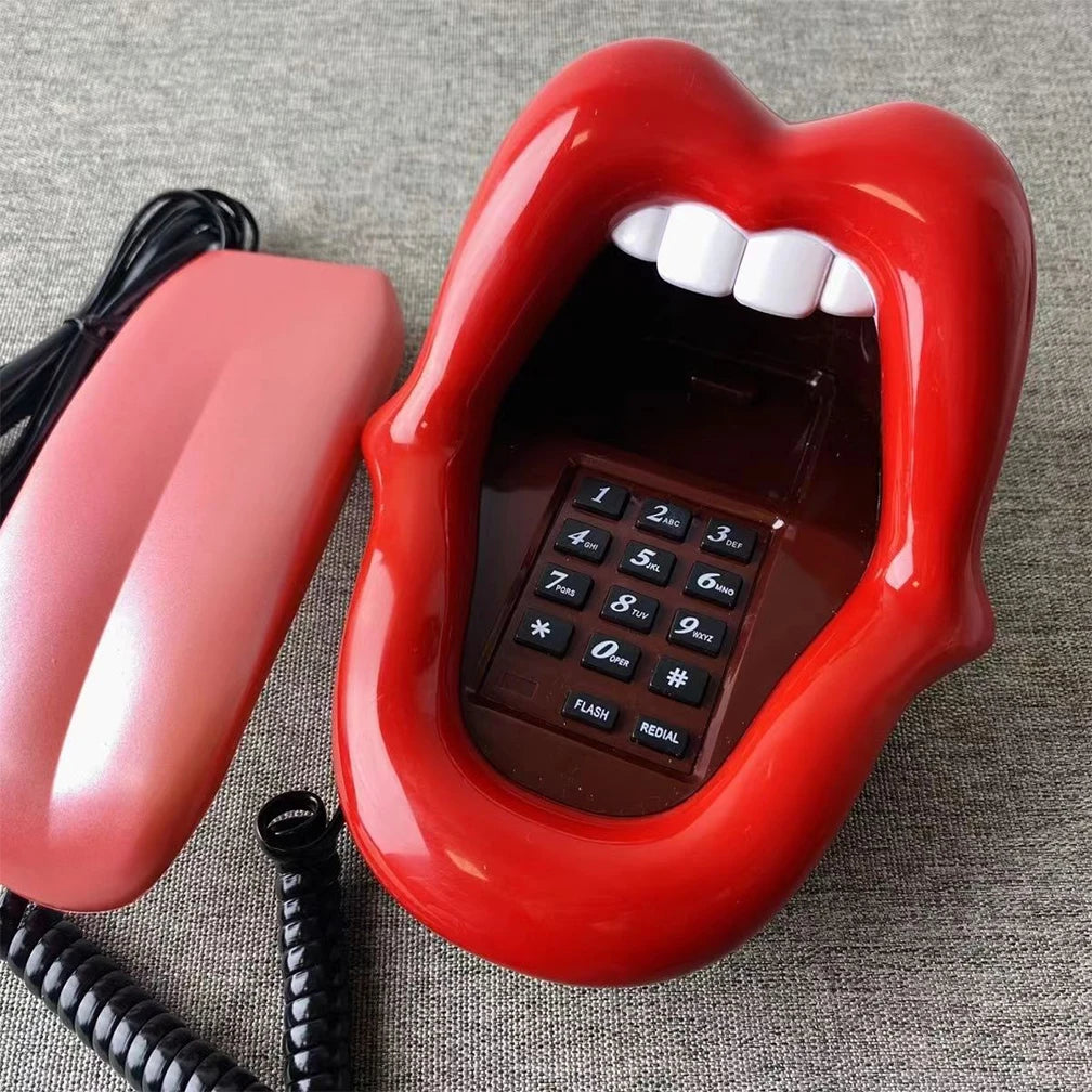 Bright red novelty corded landline phone shaped like a mouth with white teeth and a black keypad.