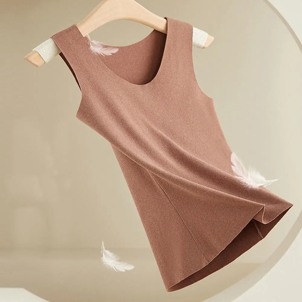 Brown knitted sleeveless vest top with a scoop neck, hanging on a wooden hanger with decorative white feathers.