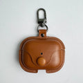 Tan leather AirPods Pro case with a flap closure, popper stud, and metal keyring clip.