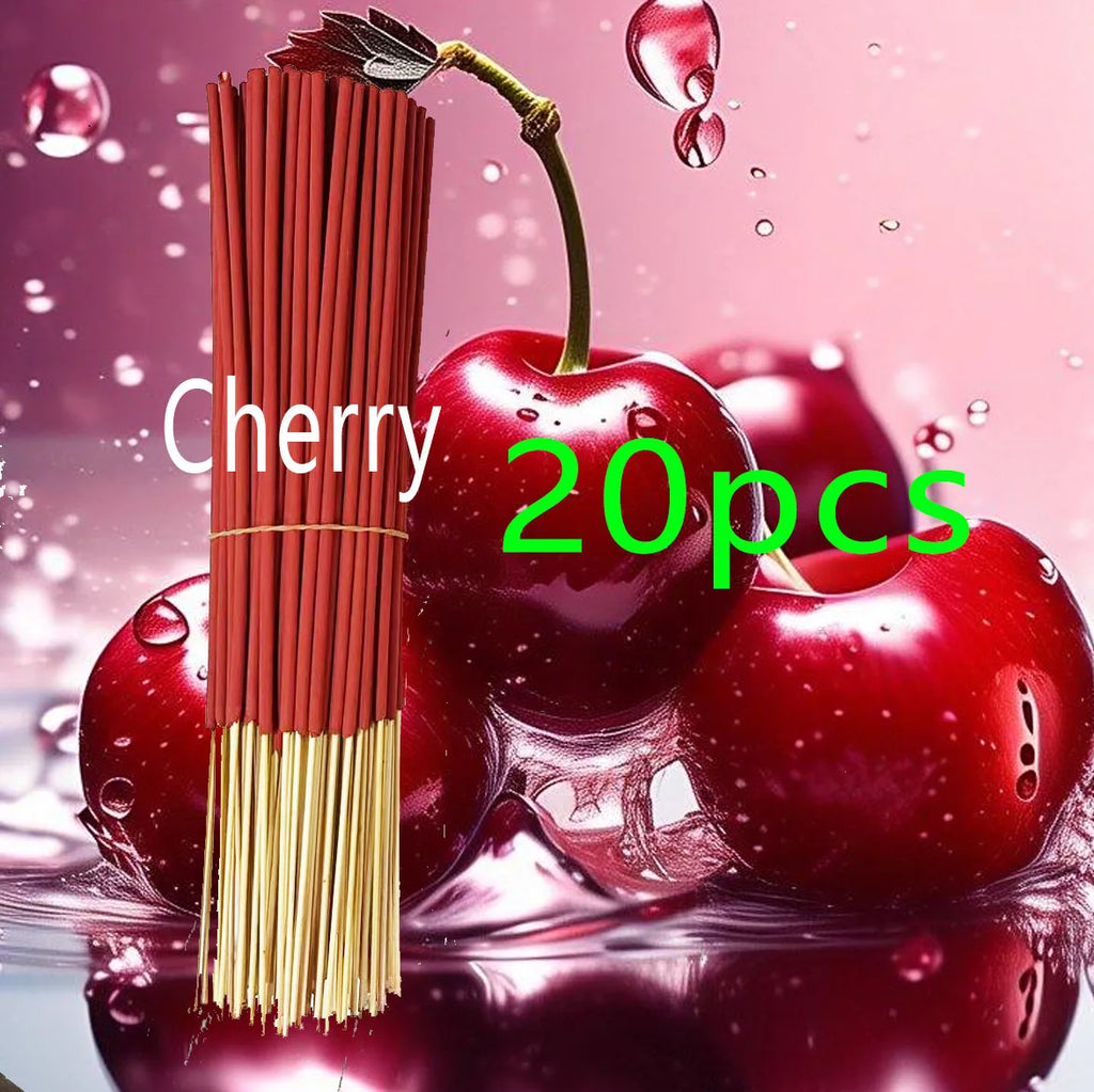 Bundle of 20 red cherry-scented incense sticks against a background of fresh red cherries.