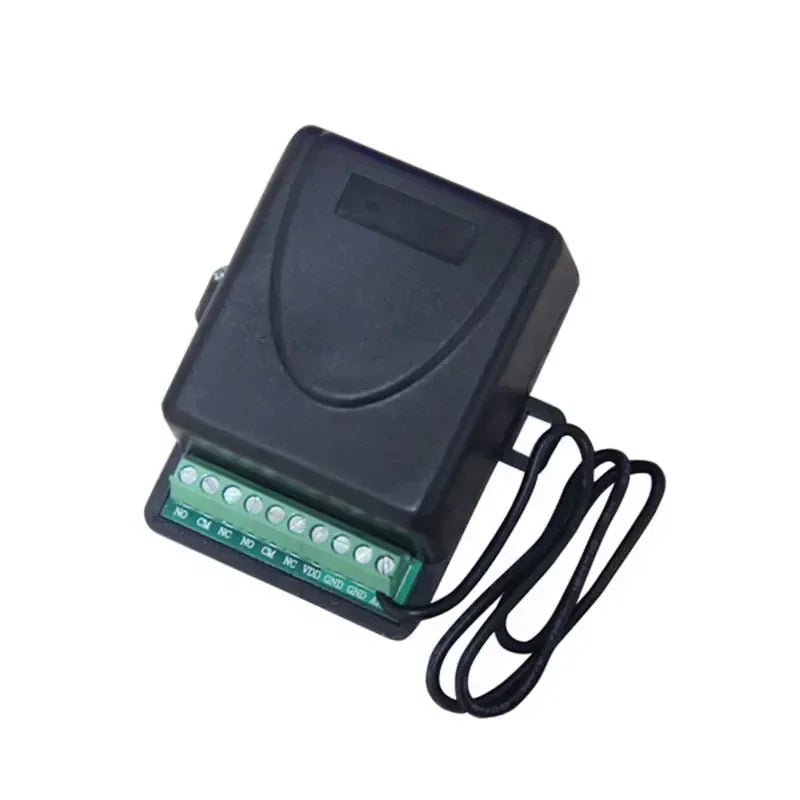 Black plastic electrical control box with a green terminal block containing screw-in wire connections.