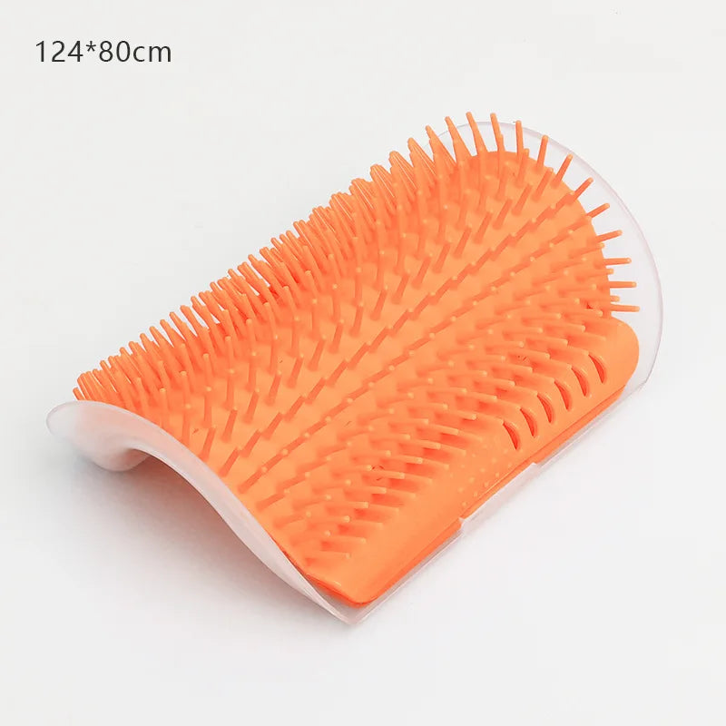 Curved orange plastic pet self-grooming wall brush with fine bristles on a white background.