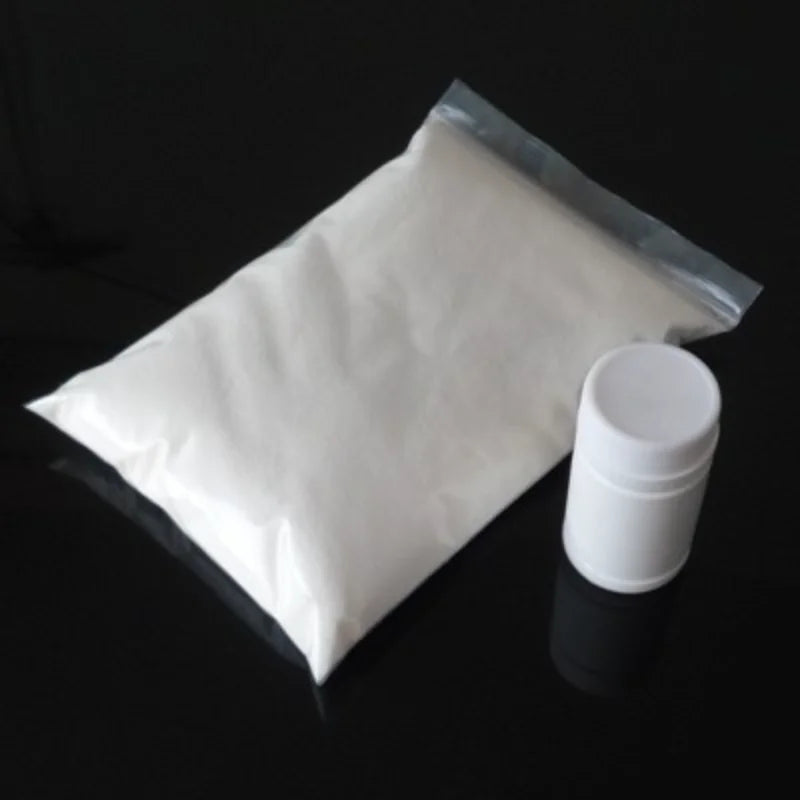 A clear plastic bag filled with white slush magic powder and a small white plastic storage container.