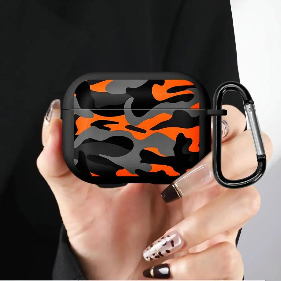 Black and orange camo silicone AirPods Pro case with carabiner held in hand.