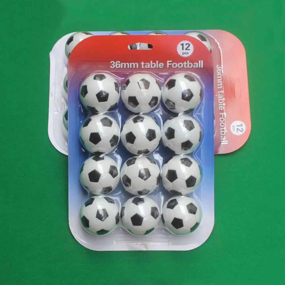 Pack of 12 black and white 36mm table football balls in clear plastic blister packaging.