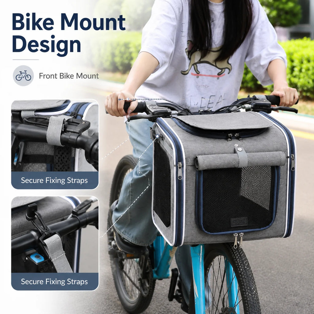 Gray pet carrier backpack mounted to the front handlebars of a bicycle with mesh ventilation windows.