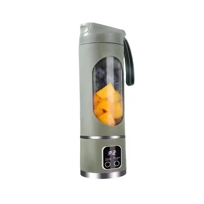 Portable sage green electric blender with a digital display, viewing window, and fruit inside.