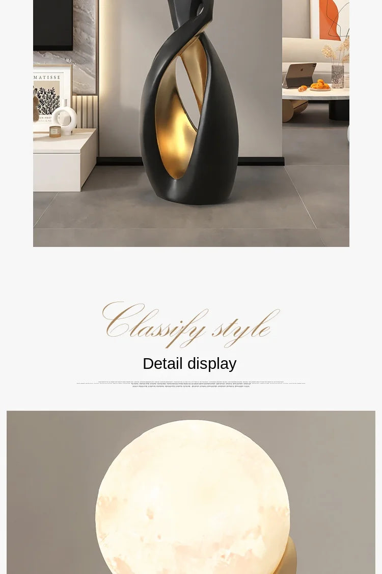 Tall, abstract floor sculpture with a matte black exterior and smooth, metallic gold interior finish.