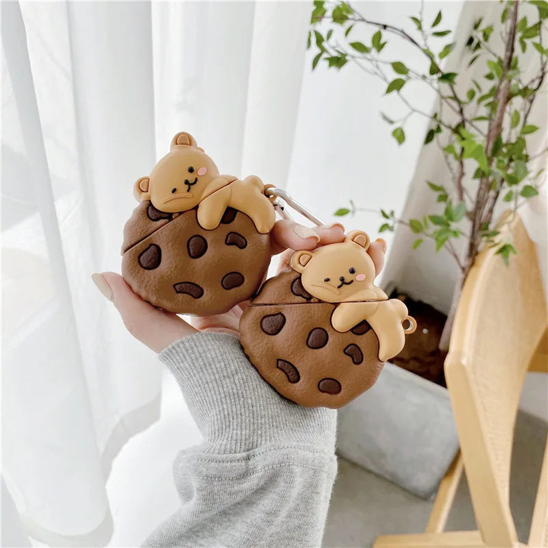 Brown cookie-shaped silicone AirPods case featuring a cute 3D bear, suitable for standard AirPods models.