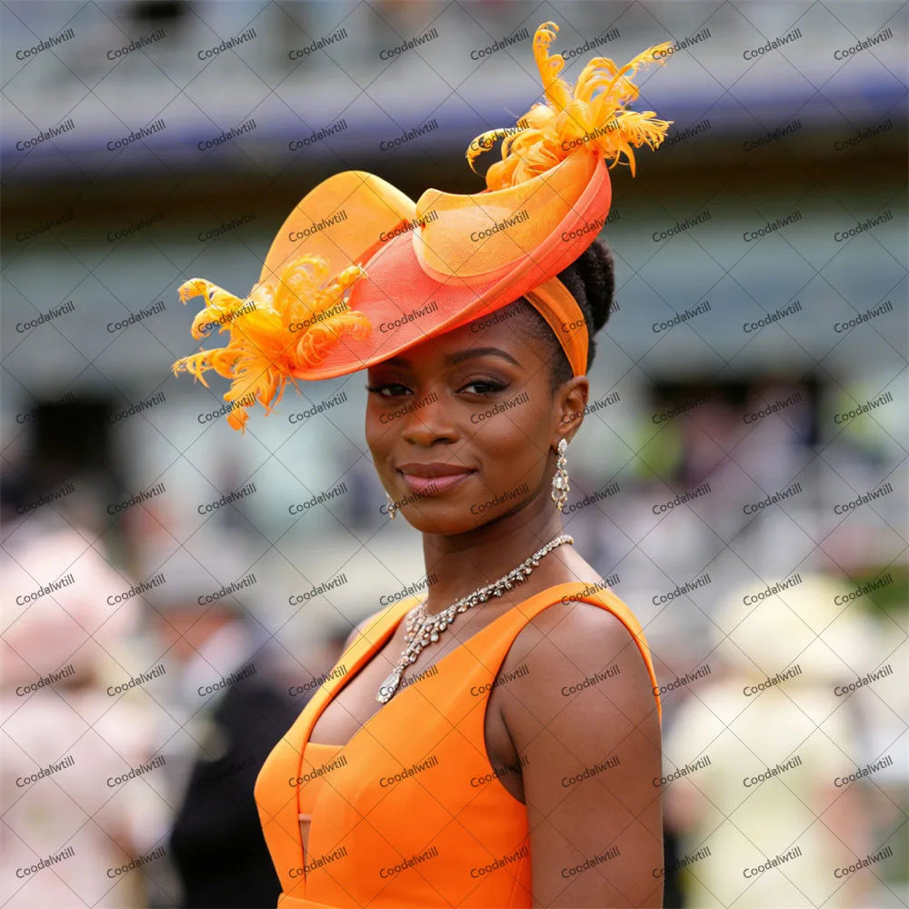 Elegant bright orange fascinator headpiece adorned with delicate feathers, worn on a headband.