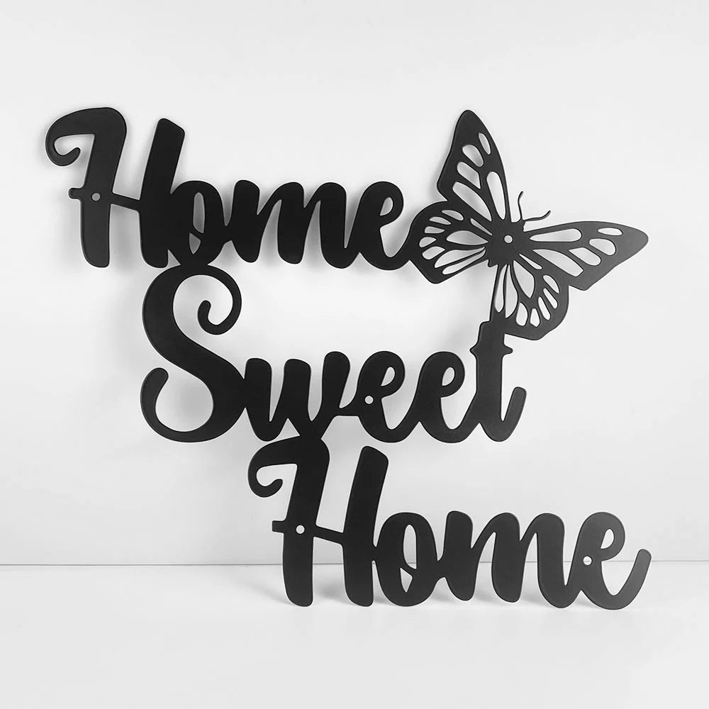 Black metal wall art featuring the words Home Sweet Home in cursive script, accented with a butterfly design.