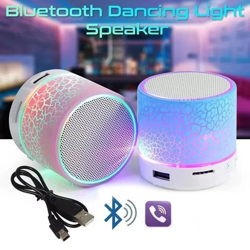 Two portable, cylindrical wireless speakers with a crackle-effect casing and glowing multicolour LED lights.