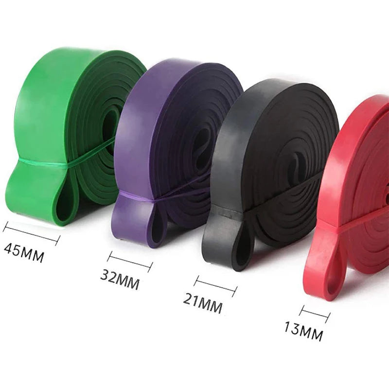 Four rolled exercise bands in green, purple, black, and red, ranging from 13mm to 45mm in width.