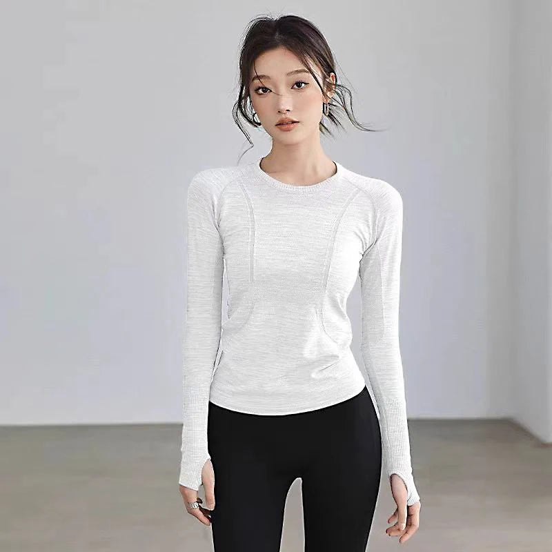 Light grey, long-sleeved athletic top with crew neck, ribbed detailing, and thumbhole cuffs.