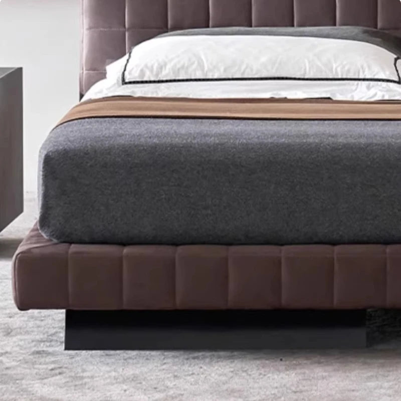 Modern Nordic-style upholstered bed frame in rich brown with a contemporary panelled, low-profile design.