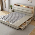 Luxury cream leather bed frame with integrated storage drawers and a built-in illuminated headboard shelf.