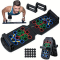 Black multi-function push-up board with colour-coded workout slots, two handles, and non-slip adhesive pads.