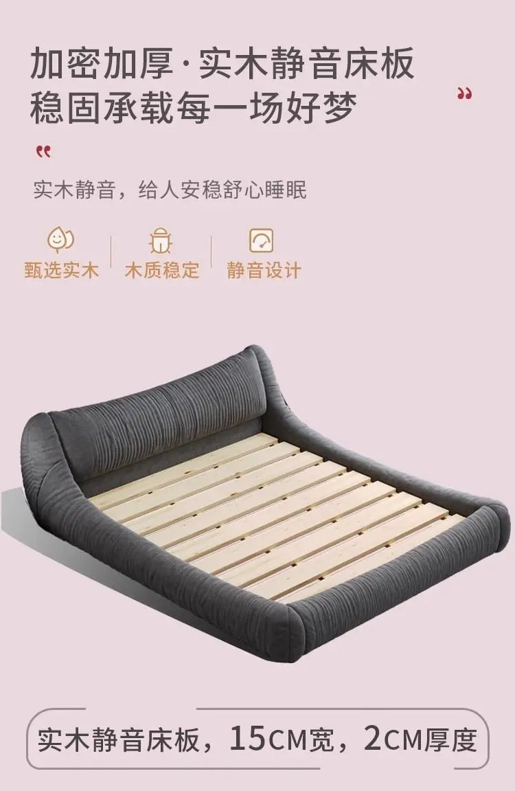 Modern dark grey upholstered bed frame featuring a low-profile design and natural wooden slats.