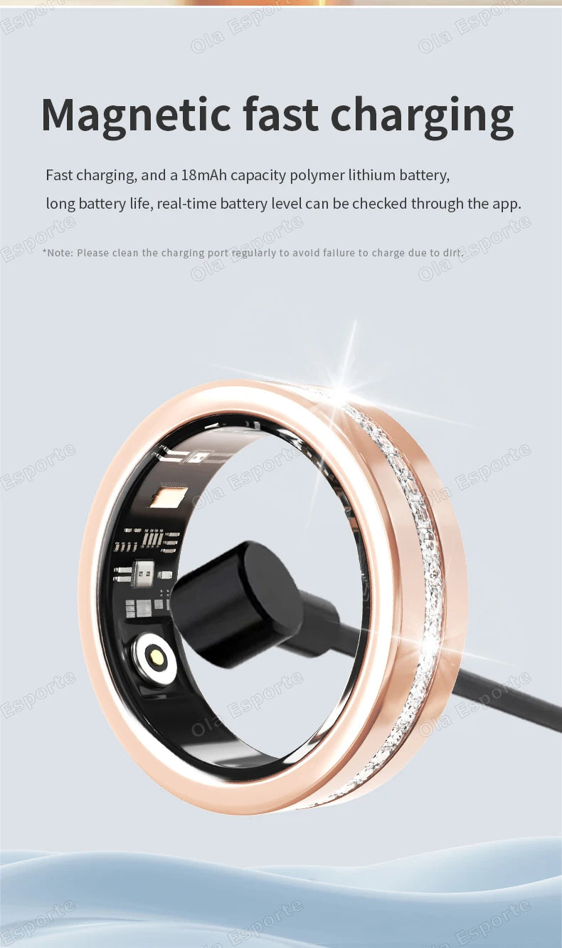 Rose gold smart fitness ring with a sparkling crystal band, showing the magnetic charging cable attached to the inside.