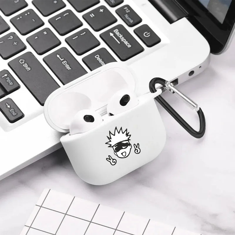 White silicone AirPods 3 case with black anime character graphic and carabiner, resting on a laptop.