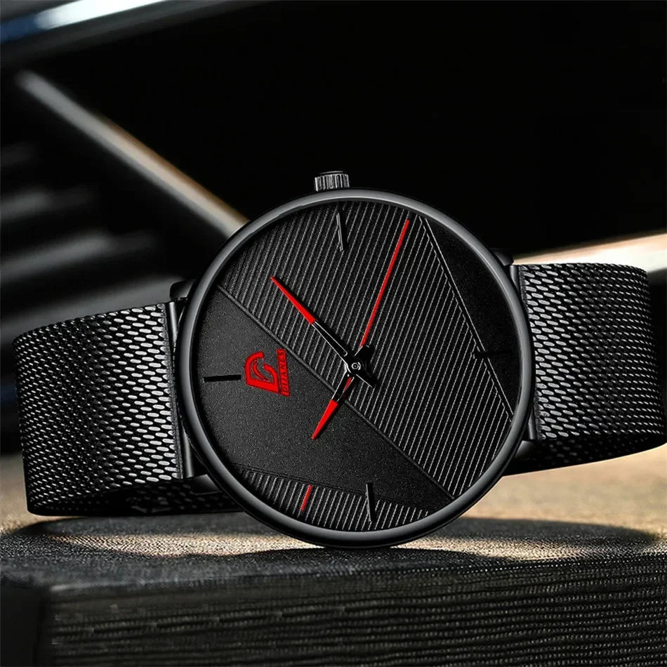 Minimalist black men's ultra-thin quartz watch with a textured dial, slim red hands and a black mesh strap.
