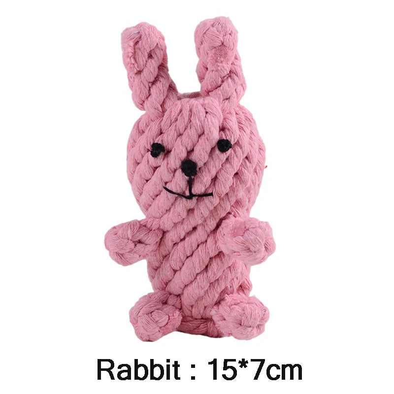 Pink woven rope dog toy in the shape of a rabbit with embroidered black eyes, nose, and mouth.