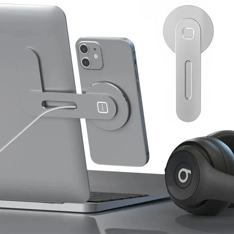 Silver magnetic phone mount attached to a laptop, featuring an adjustable arm and cable management slot.