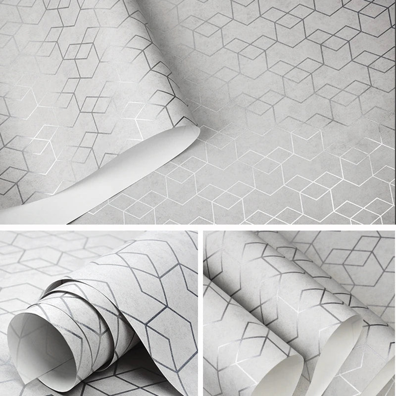 Modern grey wallpaper with a repeating metallic silver geometric cube pattern on a textured matte background.