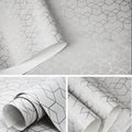 Modern grey wallpaper with a repeating metallic silver geometric cube pattern on a textured matte background.