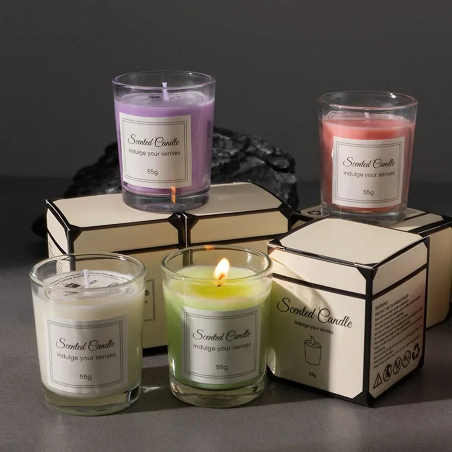 Four 55g scented candles in glass jars with gift boxes, featuring white, pink, purple, and green wax.
