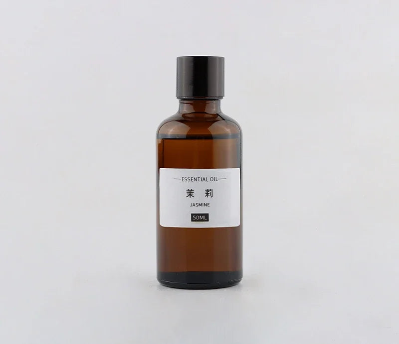 50ml amber glass bottle of jasmine essential oil with a black screw cap and simple white label on a white background.