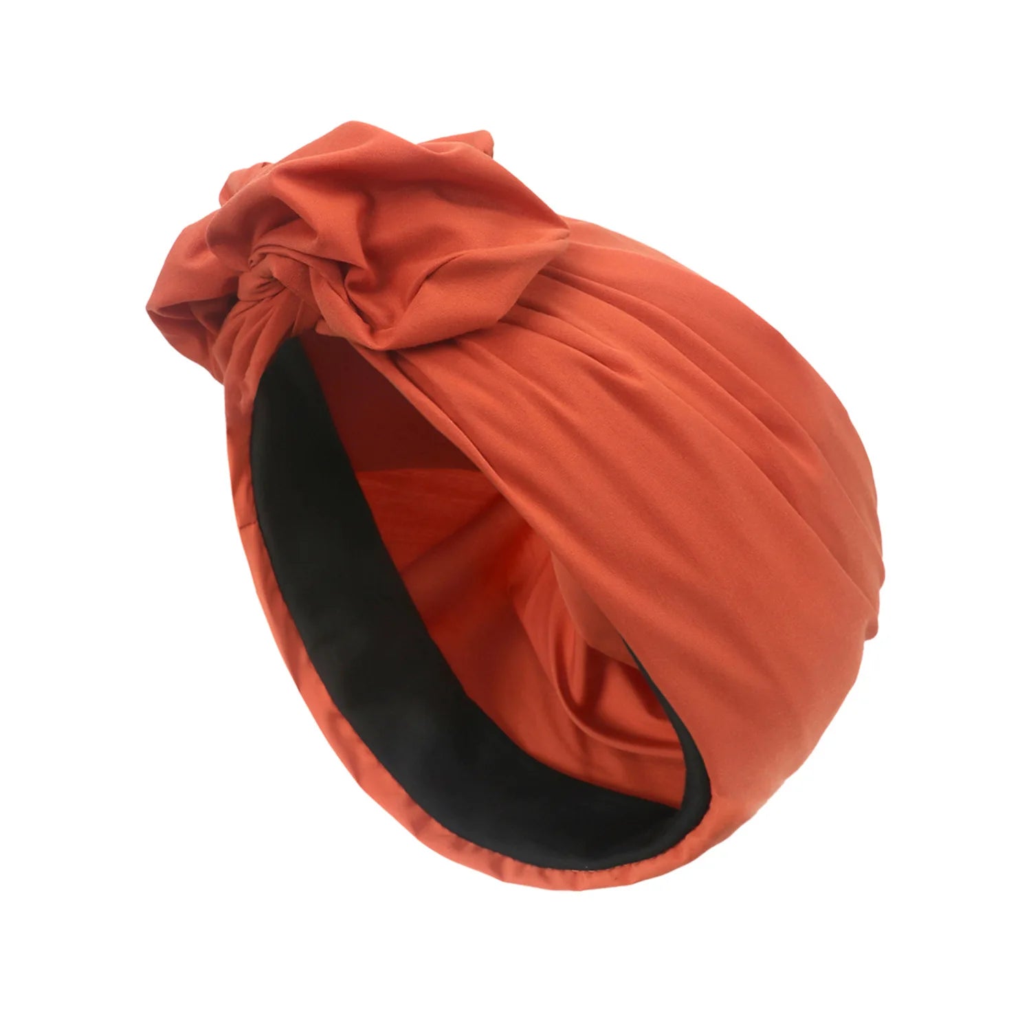 Rust-coloured vintage style knotted turban hat with a contrasting black inner lining.