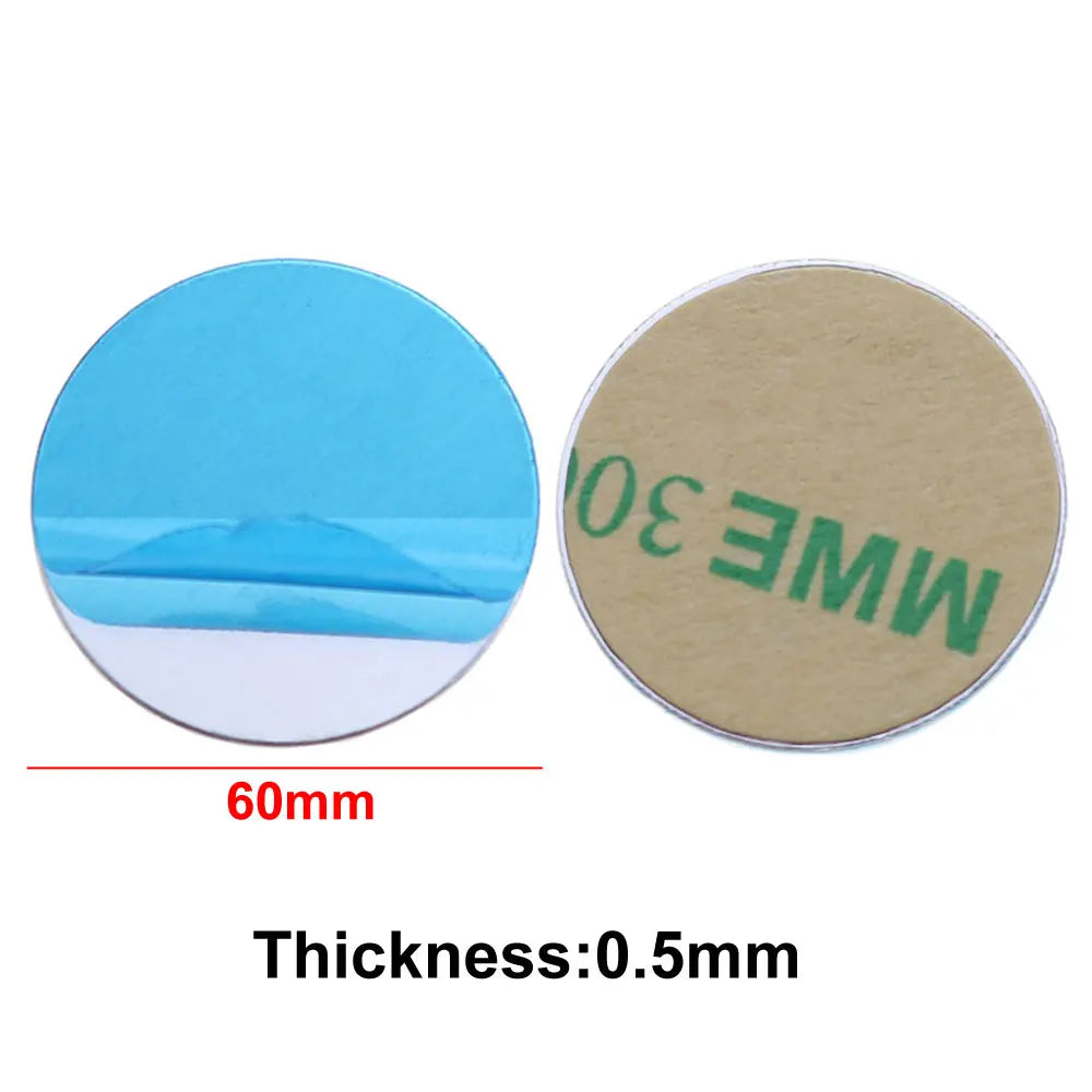 Two 60mm circular adhesive pads: one with a blue protective film, the other with a tan paper backing.